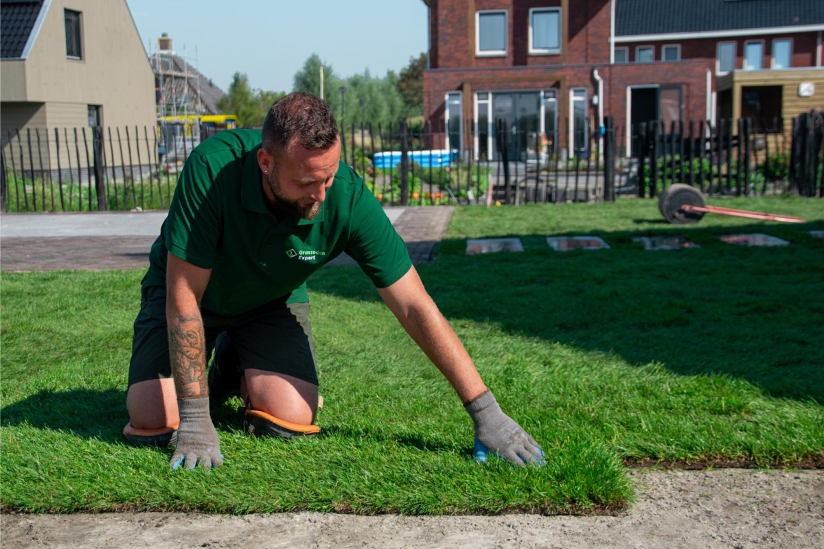 Persoon die graszoden aanlegt in Enkhuizen